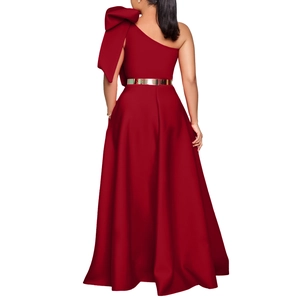 Detail of red one-shoulder evening gown with giant bow decoration and gold belt