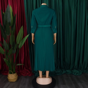 Rear view of an elegant dark green pleated maxi dress with shirt collar and waist belt