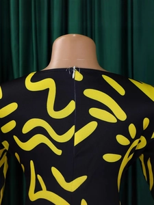 Back view of African print short sleeve midi dress with yellow abstract floral pattern