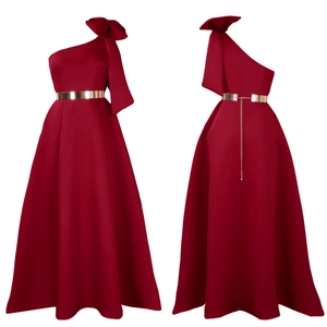 Detail of burgundy one-shoulder gown featuring a large bow and gold metallic belt