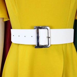 Detail of a wide white leather belt featuring a silver metal D-shaped buckle on a yellow dress