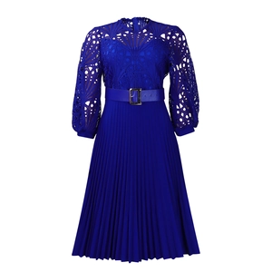 Macro view of royal blue lace crochet bodice and pleated skirt texture with a waist belt