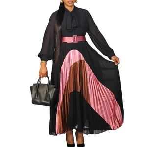 Detailed view of the pleated color-block hem and lace-up neckline on this elegant dress