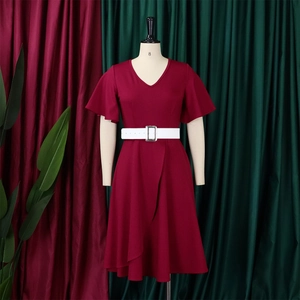 Detail of burgundy V-neck dress with ruffle sleeves and wide white buckled belt