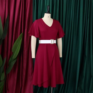 Detail of elegant V-neck plus size dress in deep red with ruffled sleeves and white belt