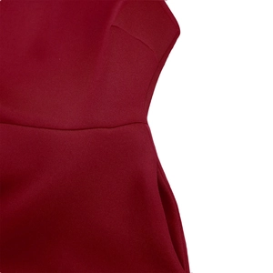 Detailed close-up showing the waist seams and side pocket of the red evening dress