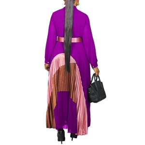 Detail of elegant pleated maxi dress back showing colorful patchwork hem and tie-up belt