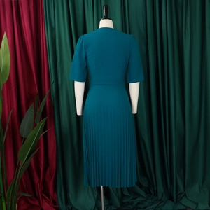 Rear view of midi dress featuring pleated skirt and waist cinch in deep teal green