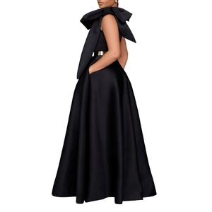 Detail of elegant black satin gown with large bow shoulder and gold metal belt