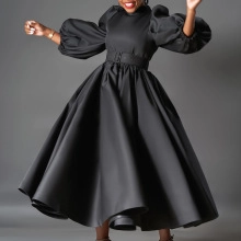 Detail of elegant black lantern sleeve dress featuring high neck and wide waist belt