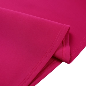 Detailed close-up of the double-needle hem stitching on a rose red evening dress