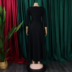 Detail view of the back of a black maxi dress featuring a round neck and waist tie belt