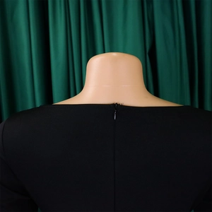 Detail of invisible back zipper on a black stretch knit dress showing quality stitching