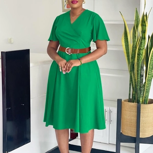 Detail view of the V-neck cross design and elegant short flared sleeves on dark green dress