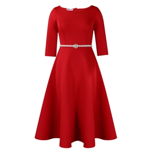 Detail of red dress waist with pearl flower belt and elegant flared skirt silhouette