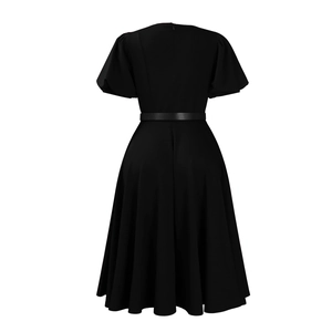 Detailed view of the invisible back zipper and adjustable waist belt on the black dress