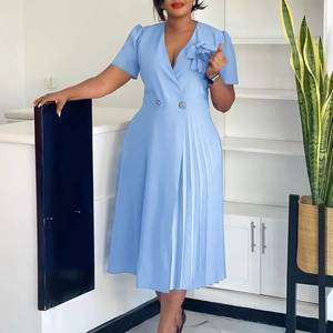 Detail of elegant light blue V-neck dress with pleated skirt and floral chest decoration