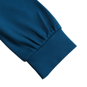 Detail of windproof ribbed cuffs with decorative pleats on a dark blue dress