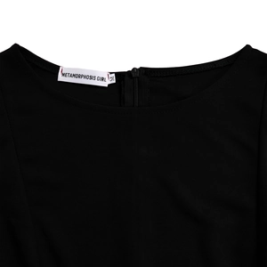Detailed view of the neckline featuring an invisible zipper and brand label on a black dress