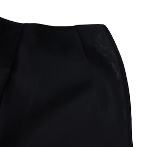 Detailed close-up showing the precise stitching and premium fabric texture of the black gown