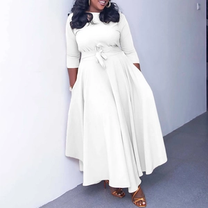 Detailed view of white long-sleeved A-line maxi dress featuring a matching waist tie belt