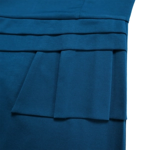 Detail of dark blue knit fabric featuring layered ruffles and neat stitching on dress