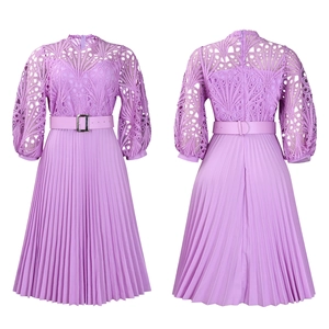 Detail of lavender lace hollow stitching and pleated skirt texture on a long sleeve dress