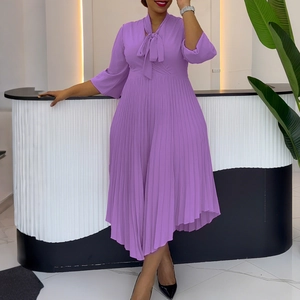 Detail view of purple pleated dress featuring a V-neck bow tie and elegant flared sleeves