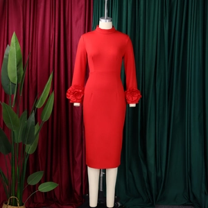 Detail of red long sleeve dress featuring dramatic 3D floral ruffles on sleeve cuffs