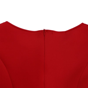 Detailed close-up of the red evening dress featuring a hidden zipper and seamless knit fabric