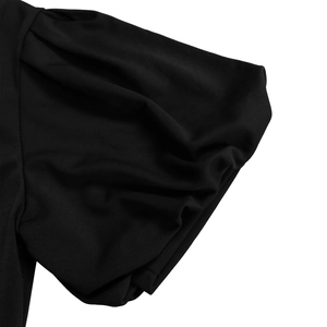 Detail of elegant black bubble sleeves and pleated cuffs on a smooth knit dress
