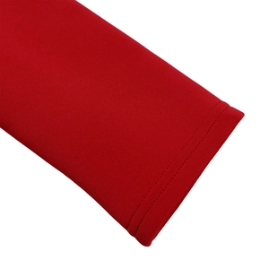 Detailed view of the red dress sleeve featuring professional double-stitch sewing seams