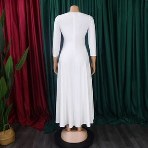 Detail view of the zipper closure on back of a white long-sleeve maxi dress