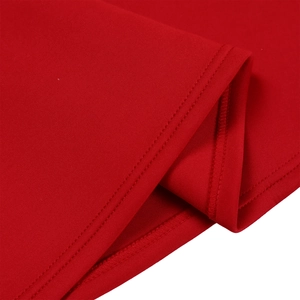 Detail of red evening dress hem featuring precise double-needle stitching and fabric texture