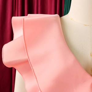 Detail of light pink dress featuring ruffled hem layers and a side slit fishtail design
