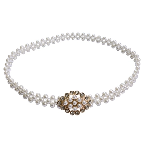 Detail of elegant double-layer pearl waist belt with a diamond-studded gold clasp