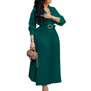 Close-up of pleated dark green maxi dress showing deep V-neckline and elegant waist belt