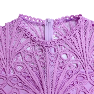 Detail of purple lace dress neckline showing intricate floral patterns and back zipper