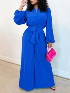 Elegant royal blue long sleeve wide-leg jumpsuit with waist tie and lantern sleeves