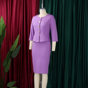 Detailed view of purple two-piece suit featuring peplum waist and gold buttons
