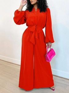 Vibrant red long sleeve wide leg jumpsuit with high waist bow belt for women
