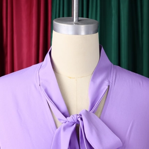 Detail of light purple chiffon blouse showing elegant pussy-bow neckline and fabric texture