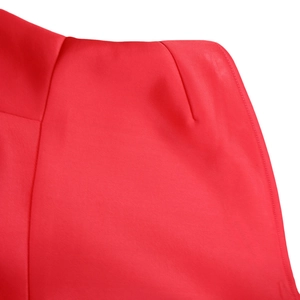 Macro detail of the shoulder stitching on a red one-shoulder formal evening dress