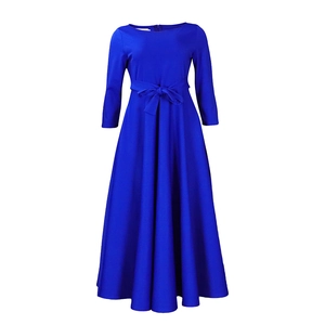 Detail of royal blue A-line maxi dress featuring a high waist tie-up bow and long sleeves