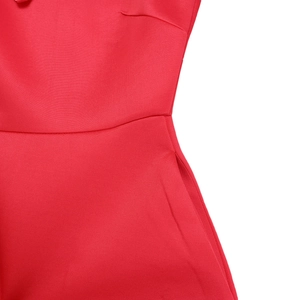 Detail of red off-shoulder gown featuring high waist stitching and functional side pockets