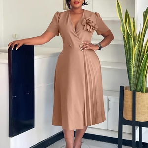 Detail of elegant V-neck khaki midi dress with pleated skirt and 3D floral brooch decoration