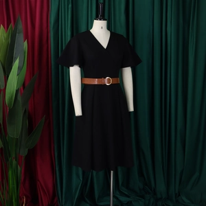 Close-up of black V-neck A-line dress featuring flutter sleeves and a brown waist belt