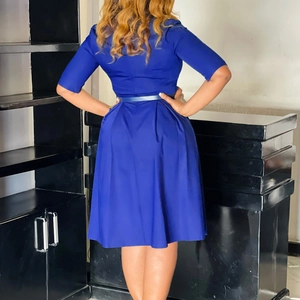 Detail of royal blue A-line midi dress featuring back pleats and thin waist belt