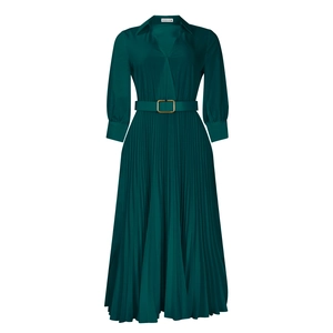 Detail of V-neck dark green pleated dress with gold buckle belt and elastic cuffs