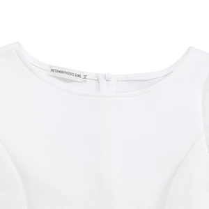 Close-up of white dress neckline with invisible zipper and Metamorphosis Girl brand label